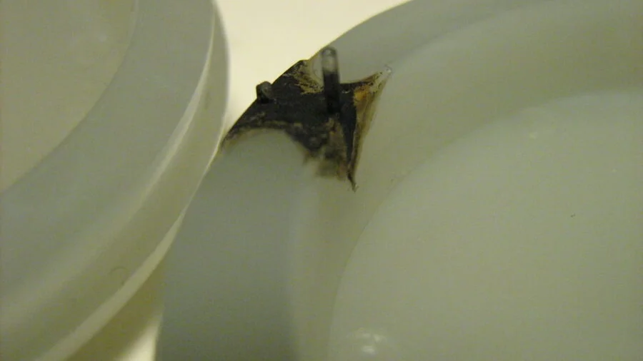 Close-up of a molded plastic part showing defects