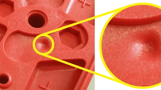 Close-up of molded plastic parts showing shrinkage marks