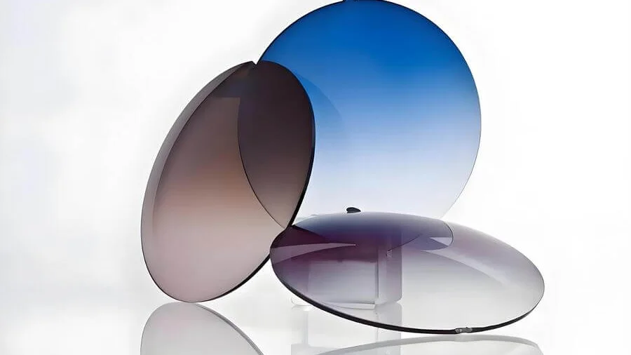 Circular sunglasses lenses in various colors arranged artistically