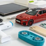 A collection of products made with two-shot molding techniques, including automotive parts and electronic devices.