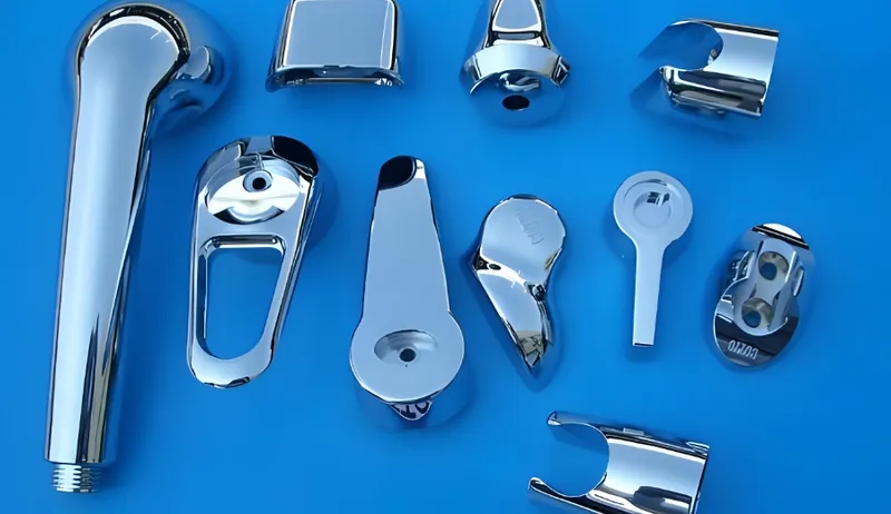 A collection of chrome plumbing parts arranged on a blue background