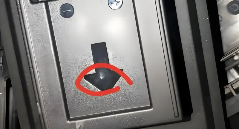 Close-up of a panel with an arrow button and two circular buttons with indicators