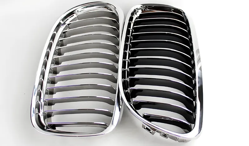 A pair of chrome BMW kidney grilles placed side by side