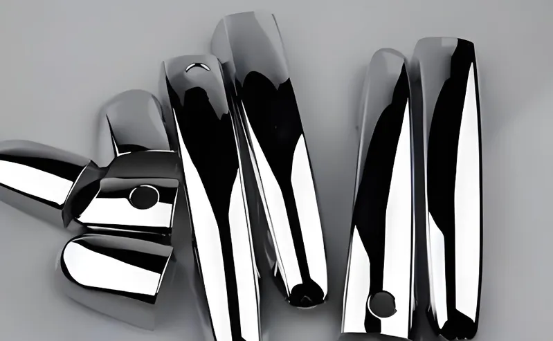 A collection of shiny chrome exhaust pipes arranged on a grey background
