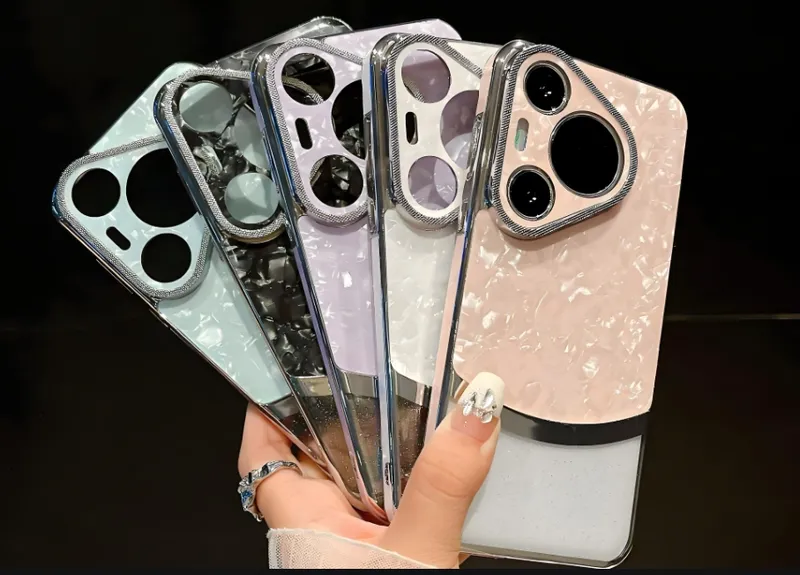 A hand holding multiple colorful smartphone cases with different pearl-like patterns