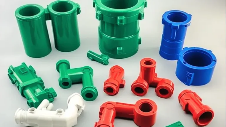 Various colorful plastic pipe connectors in green, red, blue, and white.