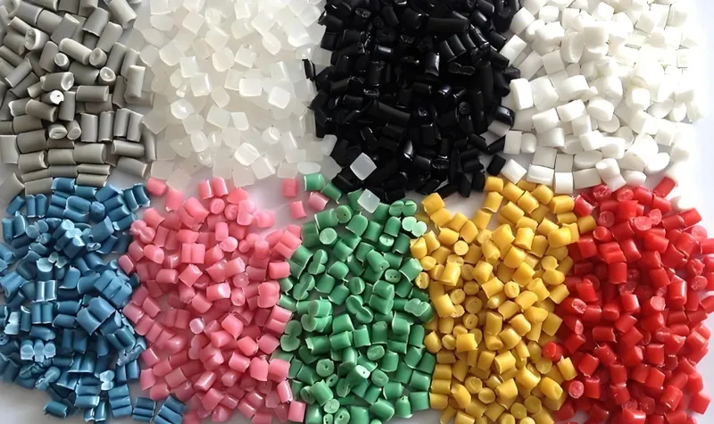 Assorted colorful polymer pellets arranged in groups by color