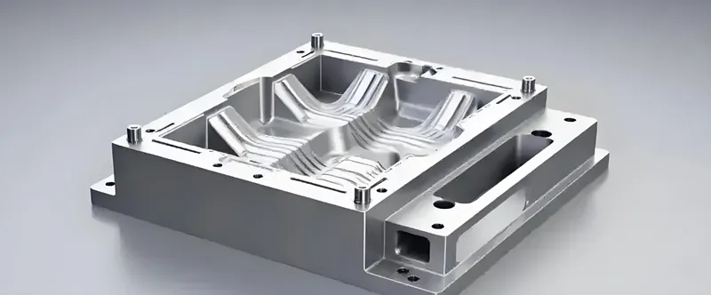 A metal mold used in manufacturing, featuring intricate grooves and sections
