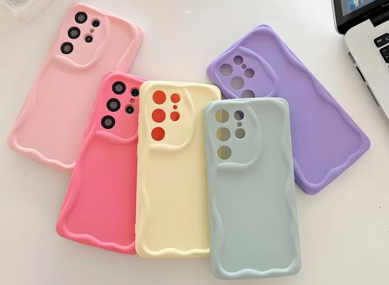 Five colorful phone cases in pastel shades in a fanned-out arrangement