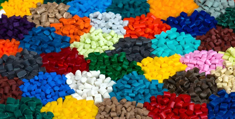 Assorted piles of colorful plastic pellets in various shades