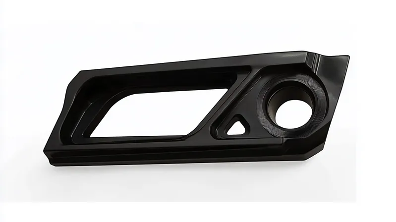 A black precision-machined camera accessory with an angular design and various cutouts