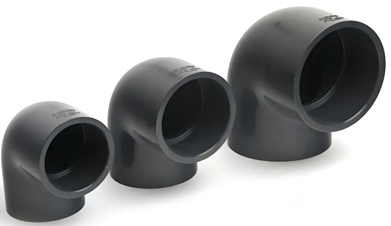 Three gray PVC elbow pipe fittings of varying sizes