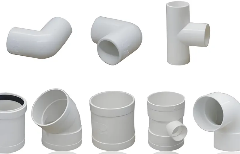 Various types of white PVC pipe fittings including elbows, tees, and couplings