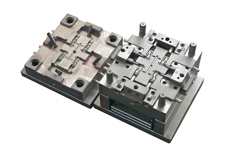 A metal mold used for injection molding, showing its detailed surface and components