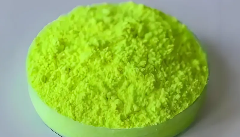 A circular dish filled with bright yellow powder
