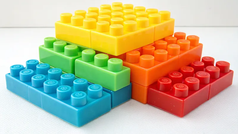 A stack of large, colorful plastic building blocks arranged in a pyramid shape