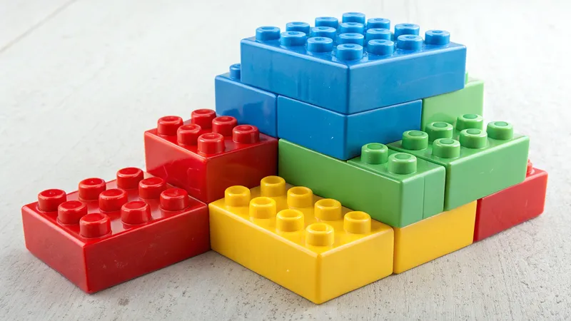 A stack of colorful plastic toy building bricks arranged on a surface