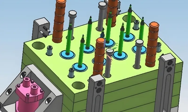 A 3D rendering of an injection mold with various components including green and orange pins and a pink base