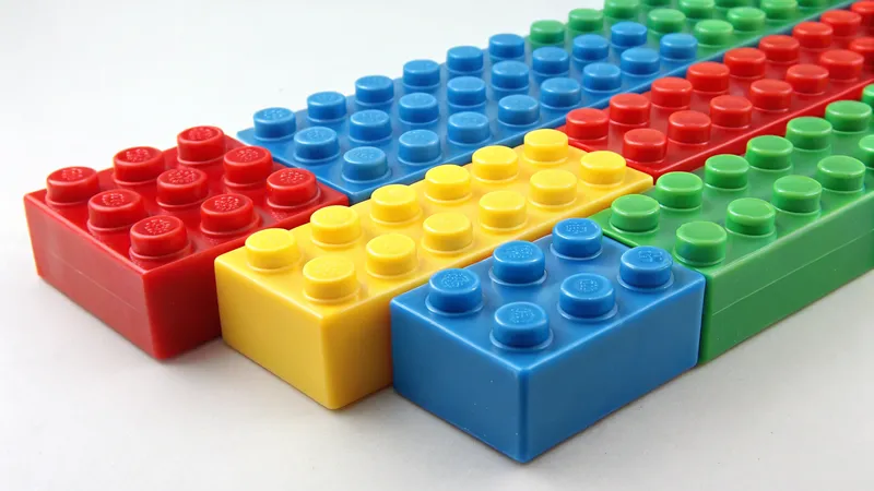 A collection of colorful plastic building blocks in red, blue, yellow, and green