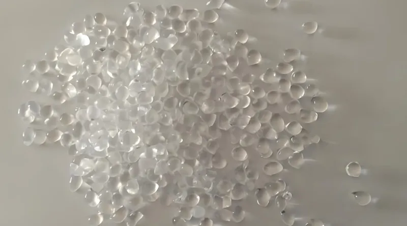 A pile of translucent plastic pellets on a white surface