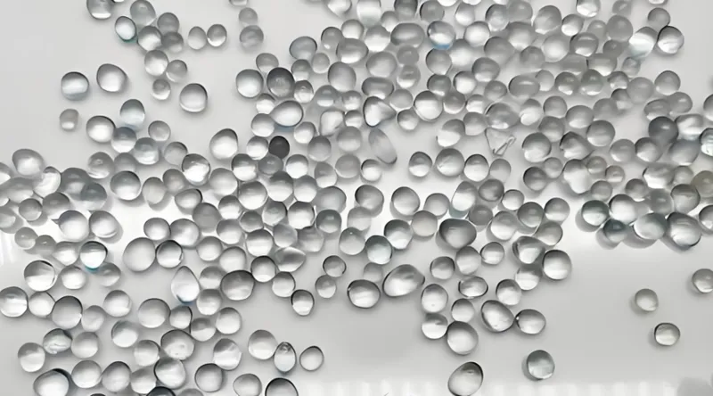 Multiple transparent silica beads scattered on a white surface