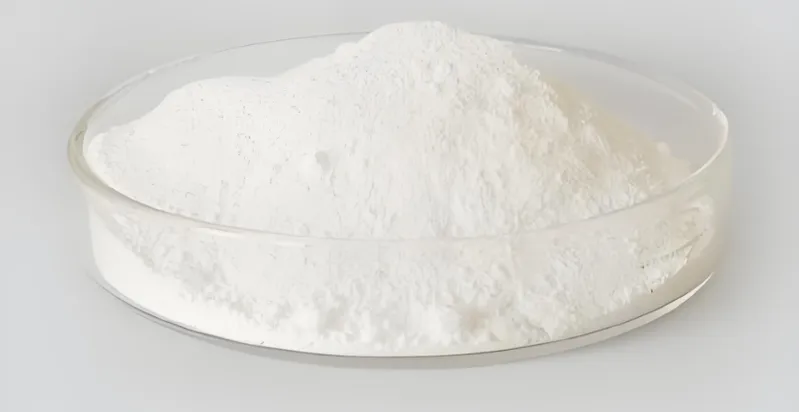 A pile of white powder in a clear petri dish on a light background